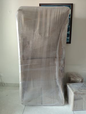 An armchair completely enclosed in clear stretch film.