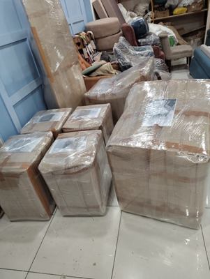 Wrapped boxes and furniture filling a room during a pack.