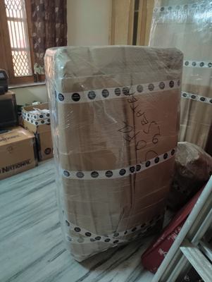 A tall stack wrapped in corrugated sheet and finished with studded edging.