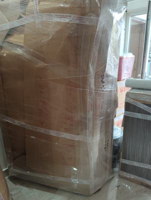 A large item wrapped in sheeting and bound with tape across its width.