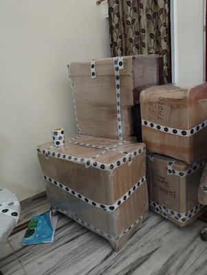 Trunks and boxes wrapped and finished with studded edge protection, stacked indoors.