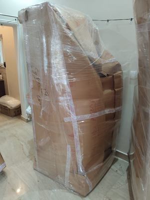 A wrapped and taped stack standing in a hallway, ready to be carried out.