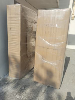 Two tall wrapped panels standing side by side on paving.